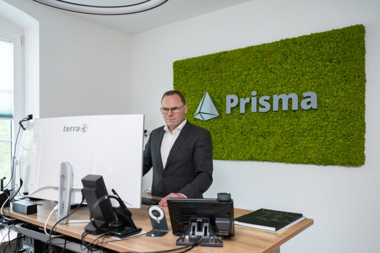 Franz Prauser steht an einem Schreibtisch